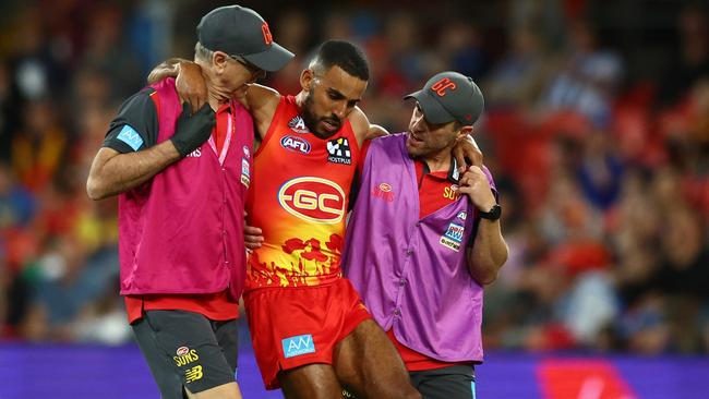 GOLD COAST, AUSTRALIA - APRIL 23: Touk Miller of the Suns is helped from the field during the round six AFL match between Gold Coast Suns and North Melbourne Kangaroos at Heritage Bank Stadium, on April 23, 2023, in Gold Coast, Australia. (Photo by Chris Hyde/Getty Images)