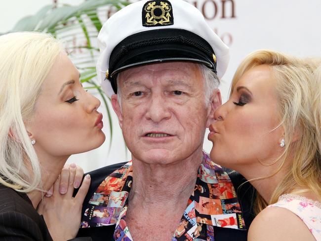 (FILES) This file photo taken on June 12, 2007 shows Playboy Magazine publisher Hugh Hefner (C) posing with playmates Holly Madison (L) and Bridget Marquardt (R) during a photocall at the 47th Monte Carlo Television Festival in Monaco.  Hugh Hefner, the silk pajamas-wearing founder of Playboy Magazine who helped steer nudity into the American mainstream died Wednesday, September 27, 2017 his magazine announced on Twitter. He was 91 years old. / AFP PHOTO / VALERY HACHE