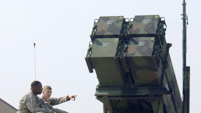 US soldiers sitting on a turret of an M2A2 Bradley Fighting Vehicle in front of a Patriot PAC-3 missile launcher. Picture: AFP