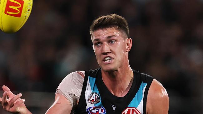 ADELAIDE, AUSTRALIA - APRIL 26: Jordon Sweet of the Power is tackled by Mitch Owens of the Saints during the 2024 AFL Round 07 match between the Port Adelaide Power and the St Kilda Saints at Adelaide Oval on April 26, 2024 in Adelaide, Australia. (Photo by James Elsby/AFL Photos via Getty Images)