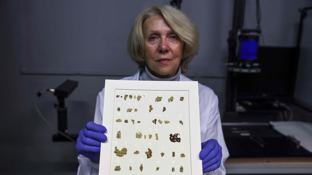 Israel Antiquities Authority (IAA) conservator Tanya Bitler displays some of the recently discovered 2000-year-old biblical scroll fragments. Picture: Menahem Kahana/AFP