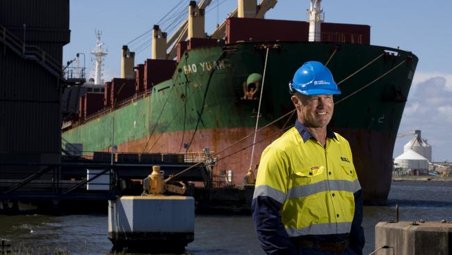 Port of Newcastle port officer Grant Innes in front of a ship laden with coal exports. Picture: Peter Stoop.