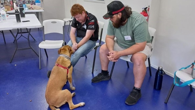 Honey the dog with participant Joshua (left) and his Happy Paws Happy Hearts carer in Mackay. Picture: Contributed