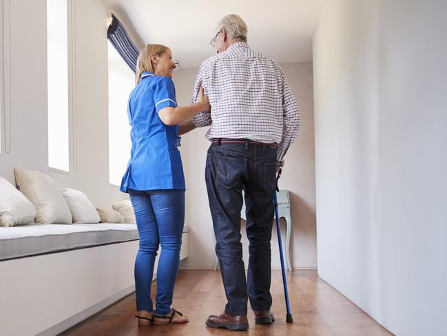 AGED CARE/NURSING HOME/SENIOR/RESIDENTIAL CARE. Picture: istock   Nurse helping senior man walk using a walking stick