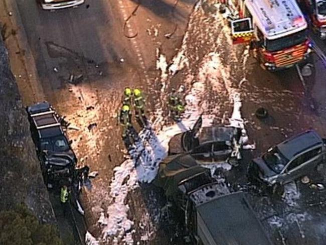 Fire fighters douse the wreckage with foam. Picture: Seven News