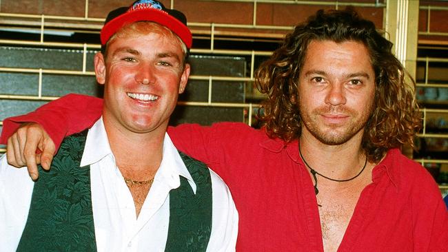 (FILE PHOTO) LONDON - 1993:  (L-R) Australian cricketer Shane Warne poses for a photo with Michael Hutchence, lead singer of INXS July, 1993 in London, England. (Photo by Getty Images)