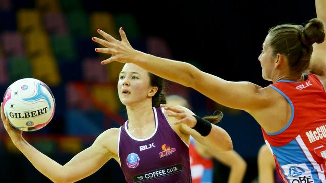 Caitlyn Nevins of the Firebirds up against tight Swifts defence.