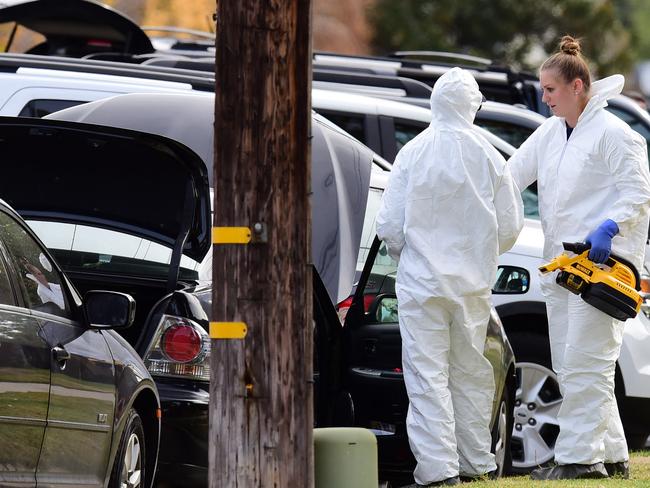 Members of an FBI Evidence Response Team ... in protective clothing examine a car in Redlands, California linked to the shooting rampage. Picture: AFP