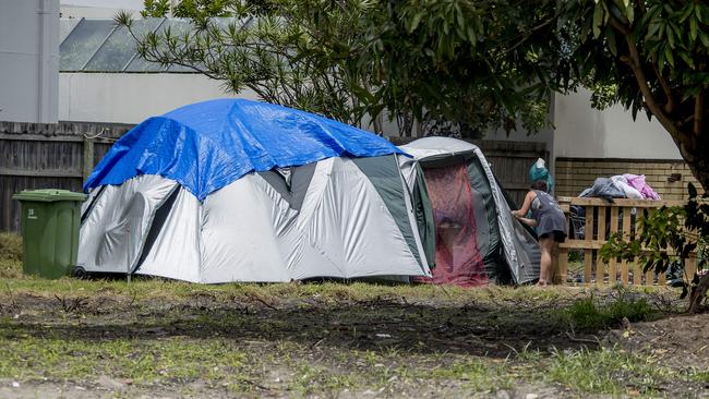 A woman potters around the tent. Picture: Jerad Williams