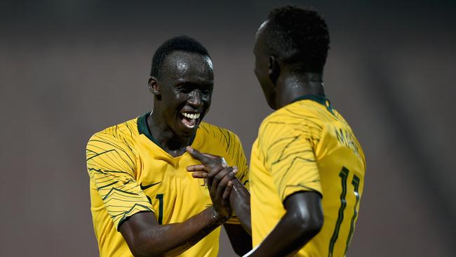 Awer Mabil (right) of Australia celebrates with Thomas Deng (left) after scoring his side’s fourth goal during the international friendly against Kuwai. Photo: Getty Images