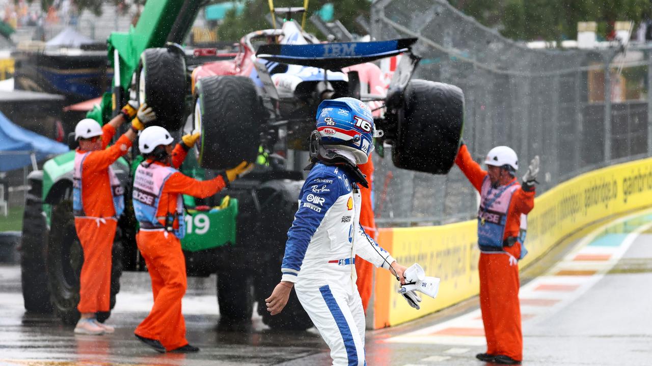 Charles Leclerc walks away as marshals recover his damaged car. Photo by CLIVE ROSE / GETTY IMAGES.