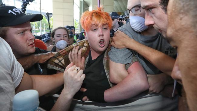 Protesters link arms to stop delegates entering their conference building. Picture: Alex Coppel.