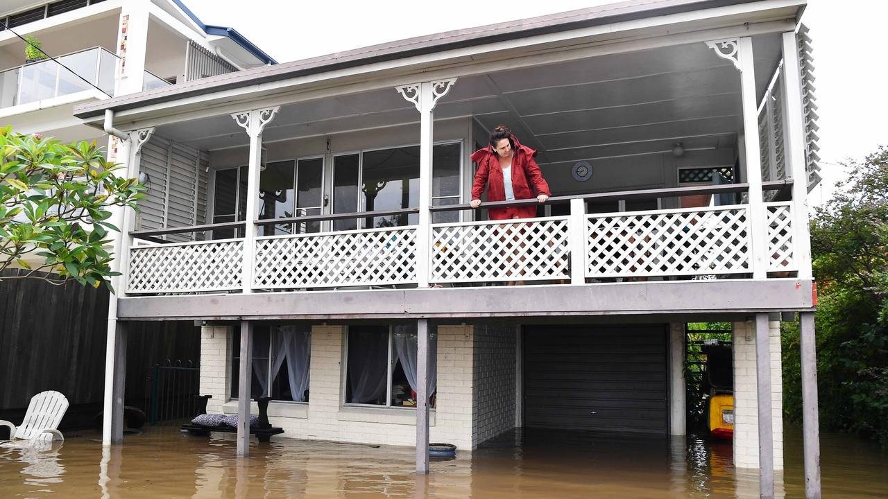 Bradman Ave remains closed as residents prepare for more rain and heavy flooding to hit the Sunshine Coast. Richelle Rae overlooks the flooded Maroochy River. Picture: Patrick Woods.