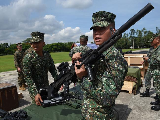 A Philippine Marine holds an M60 machine gun during a handover ceremony of weapons from the US military in Manila last week. The United States have given counter-terrorism weapons to help the Philippine military fight Islamic militants. Picture: Ted Aljibe/AFP