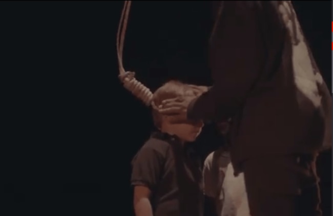 The noose is placed around the boy’s neck in the video. Source: YouTube