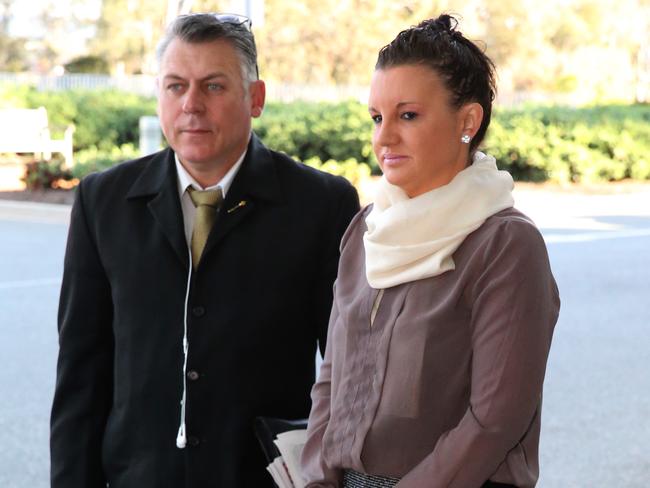 Rob Messenger and Jacqui Lambie arrive at Parliament House, Canberra, during 2014.