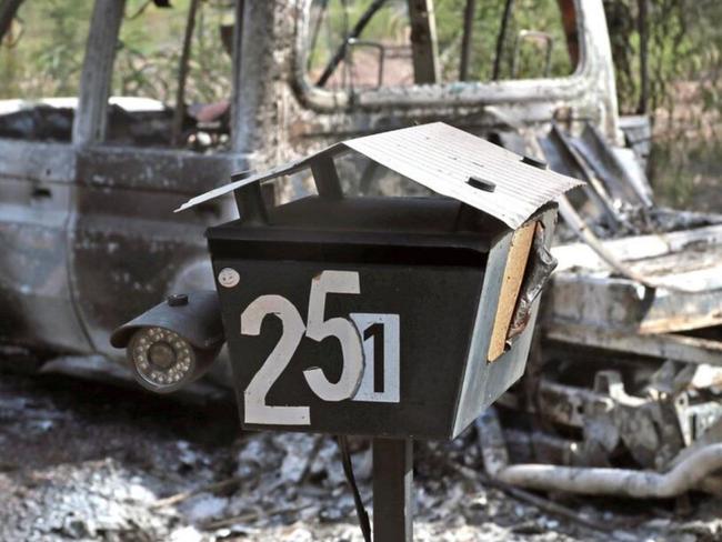 A burnt out car at the entrance to the Train property at Western Downs.