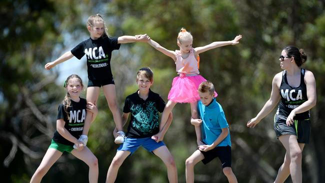 Melbourne Cheer Academy is running a school holiday program for children to learn dance and cheer skills. Ariana, Ella, Jasper, Isla, and Fletcher get to grips on some moves with help from Danelle Cooney at the Bill Sewart Athletics Track in Burwood East. Picture: Steve Tanner.