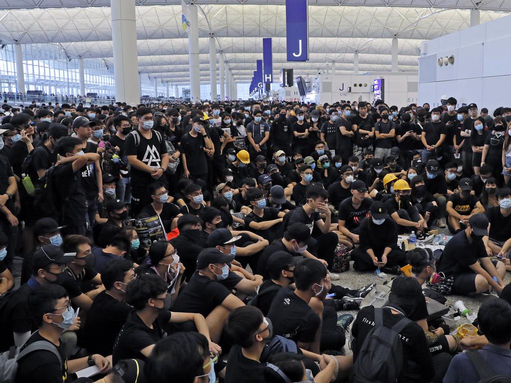 More than 5000 protesters streamed into one of the world’s busiest transport hubs and quickly transformed the arrivals hall into a sea of black yesterday.