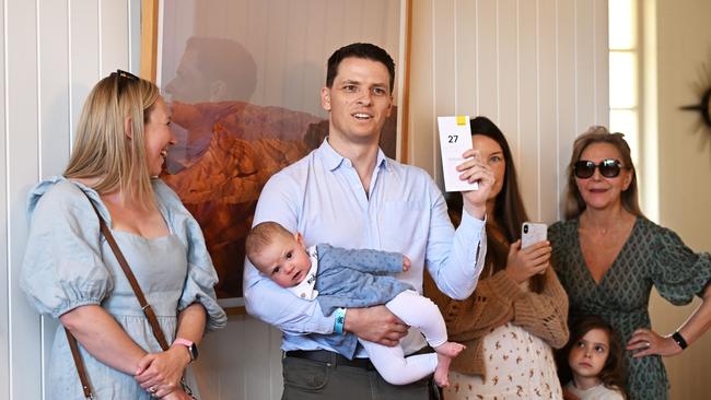 A young couple bids during an auction of a house in Bardon, in Brisbane’s inner-west. Picture: Dan Peled