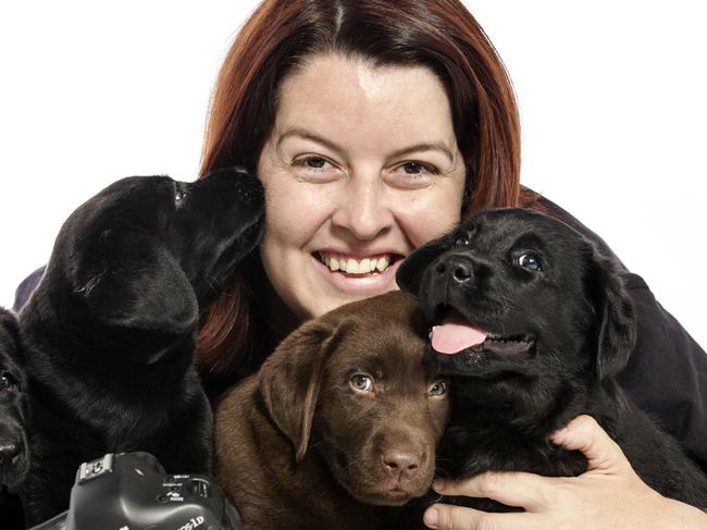 Photographer Alex Cearns is about to be announced as the new ambassador for Guide Dogs WA pictured with Labrador puppies in her studio space in North Perth. Natasha Edge (long dark hair) & Margie Bradley (blond) form Guide Dogs WA.