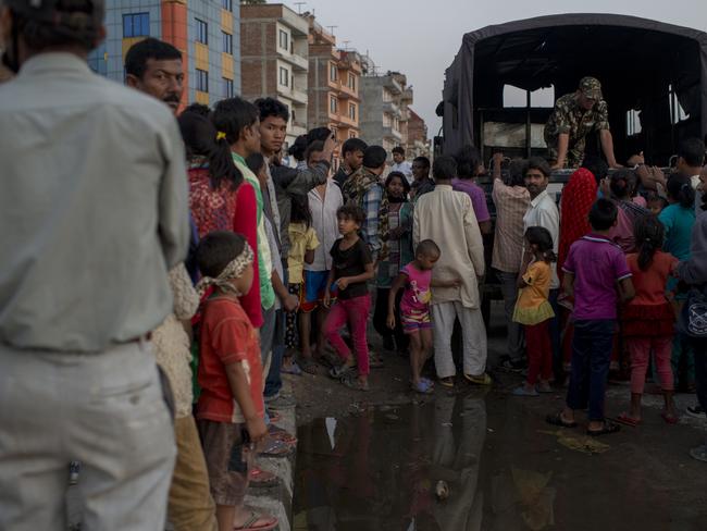 KATHMANDU, NEPAL - MAY 12: Residents of Kathmandu who moved out in the open and set up temporary tents, stand in line to get emergency help of the military following a second major earthquake May 12, 2015 in Kathmandu, Nepal. A 7.3 magnitude earthquake has struck in Nepal only two weeks after more than 8,000 people were killed in a devastating earthquake. The latest quake has struck near Mt Everest near the town of Namche Bazar. Tremors have been felt as far away as Bangladesh and Delhi. (Photo by Jonas Gratzer/Getty Images)