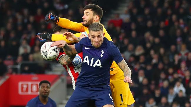 Tottenham goalkeeper Hugo Lloris attempts to clear over teammate Toby Alderweireld and Southampton’s Danny Ings. Picture: Getty Images