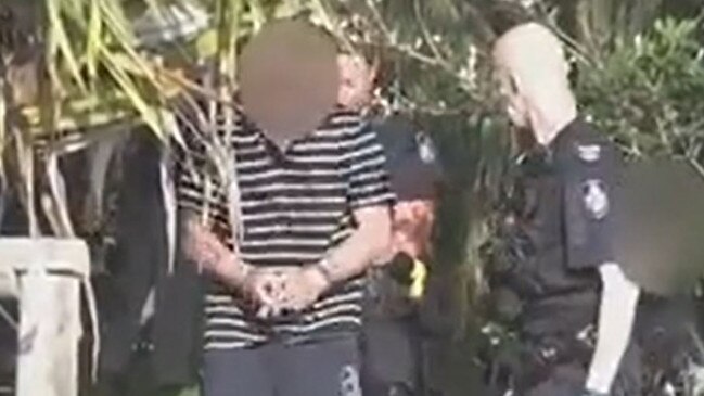 Police take a man into custody over an alleged slashing at Kirra. Picture: 9News Gold Coast