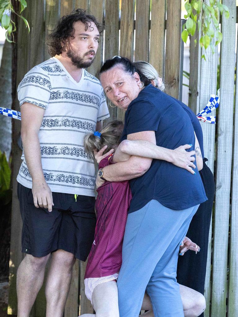 Family and friends at the house in Grange where a man was shot dead by police. Picture: Richard Walker