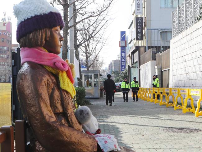 This picture taken on January 2, 2017 shows a statue (L) of a teenage girl symbolizing 