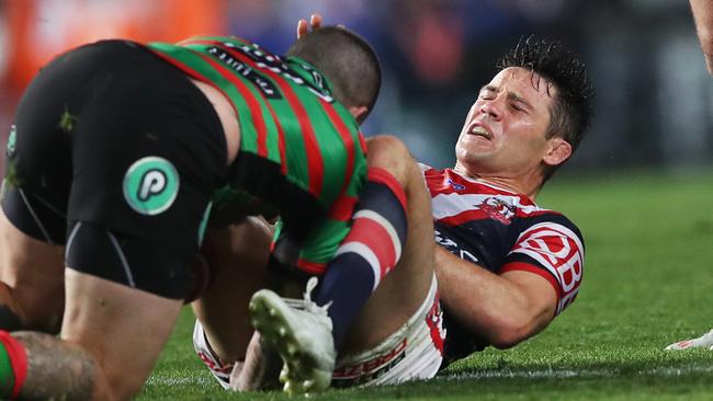 Roosters halfback Cooper Cronk hits the deck after an Adam Reynolds tackle. Picture. Phil Hillyard