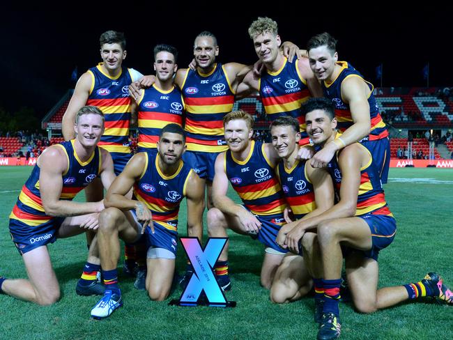 The Adelaide Crows pose for photographs after winning the AFLX grand final match.