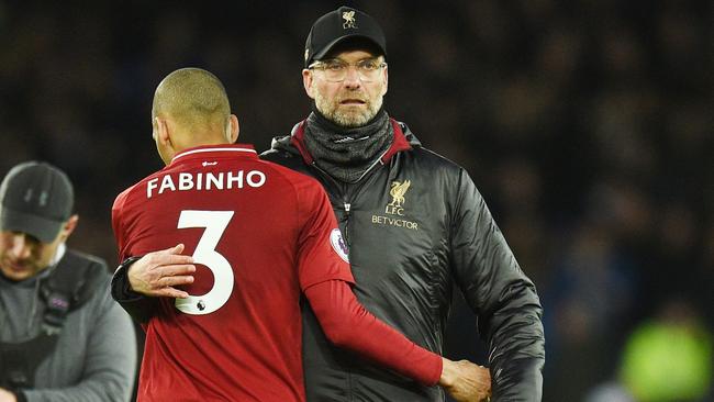 Liverpool's Brazilian midfielder Fabinho is embraced by Liverpool manager Jurgen Klopp after their draw against Everton. Picture: AFP