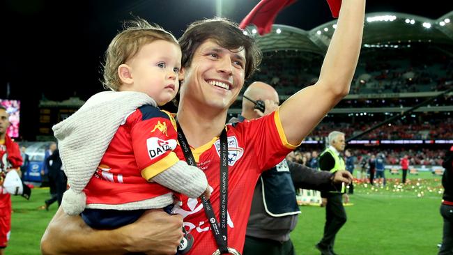 Pablo Sanchez, with his son Pablo Jnr, salute the Adelaide United supporters for the last time, before his departure from the club. Picture: Sarah Reed