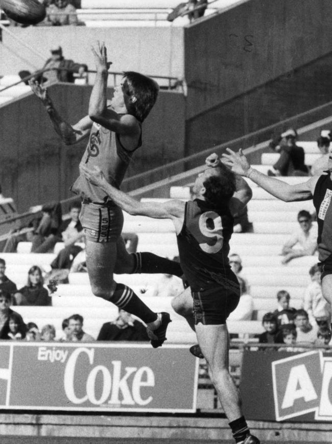 Peter Motley flies for a mark in front of West Adelaide’s Richard Hamilton in 1985.