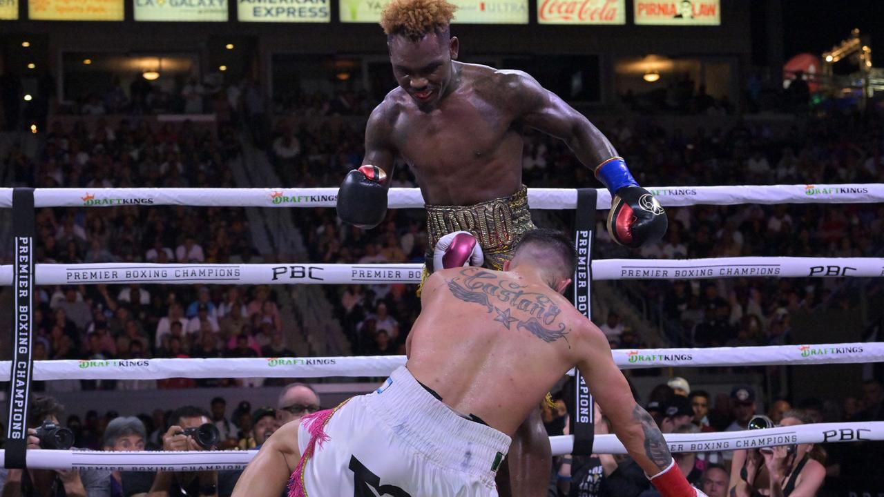 CARSON, CA - MAY 14: Jermell Charlo (gold/red shorts) knocks down Brian Castano (white/pink shorts) during their super middleweight title fight at Dignity Health Sports Park on May 14, 2022 in Carson, California. Charlo won by knockout in the 10th round. (Photo by Jayne Kamin-Oncea/Getty Images)