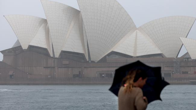 A woman walks in the rain in Circular Quay on Thursday. Picture: NCA NewsWire / Damian Shaw