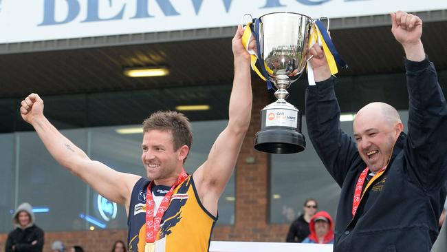 Beaconsfield captain Daniel Mislicke and coach Clint Evans celebrate the 2014 premiership win. Picture: Susan Windmiller