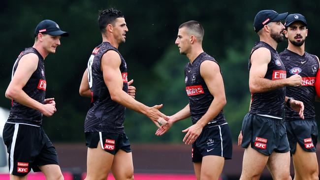 Scott Pendlebury (centre left) with a freshly-trimmed Nick Daicos (centre right) at Collingwood pre-season training on Monday. Picture: Mark Stewart