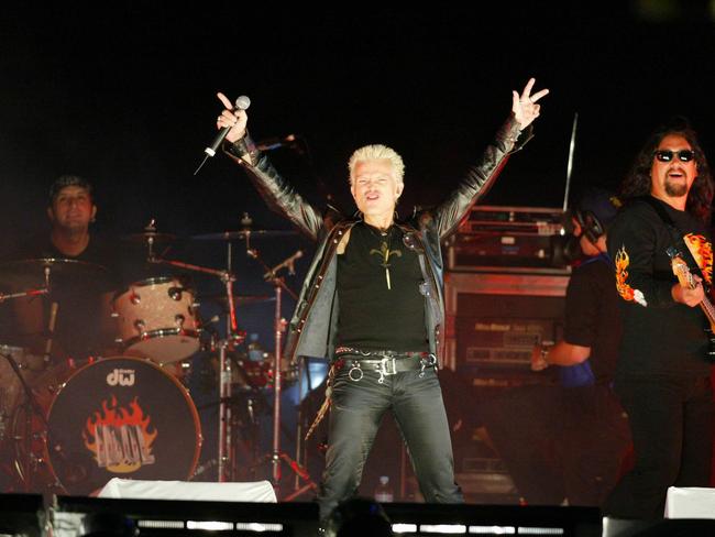 Singer Billy Idol tries to get the crowd going, despite there being no sound during his performance at the 2002 NRL grand final. Picture: Gregg Porteous.