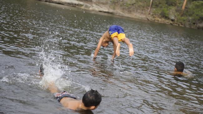 Swimmers take the plunge at Parramatta Lake during the hot weather.