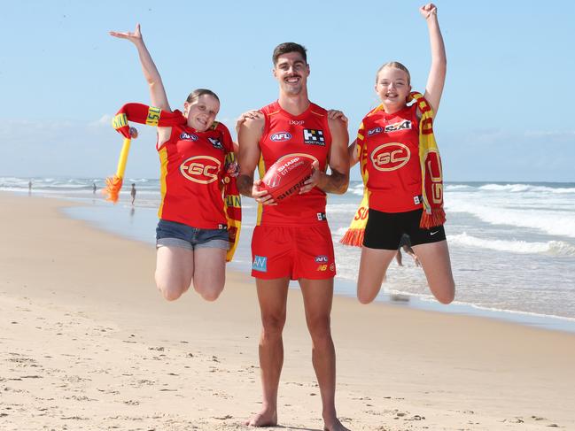 Primed for a big weekend of sport for the Gold Coast Suns are player Alex Sexton and fans Kayla Smith and Bonnie Stott.. Picture Glenn Hampson