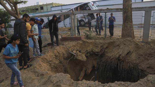 Palestinians inspect the site of an Israeli army air strike on the European hospital in Khan Younis. Picture: AP.