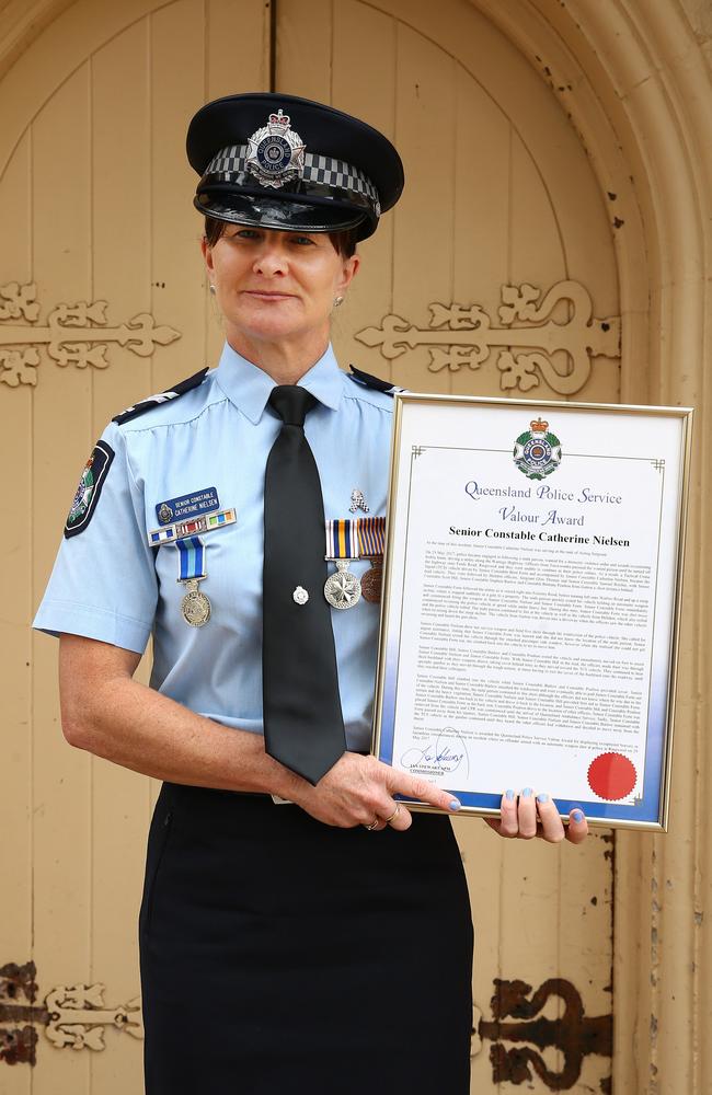 Senior Constable Catherine Nielsen with her bravery award for attempting to save the life of her partner Brett Forte. Picture: Liam Kidston.