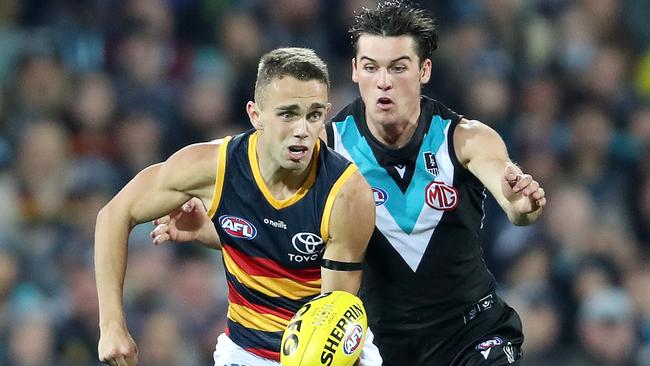 Power young Connor Rozee, pictured tackling Lachie Sholl, has failed to recapture his best form this season. Picture: Sarah Reed/AFL Photos