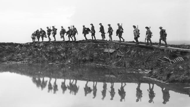 Men from the 1st Australian Division in Ypres, Flanders, on their way to the front line to relieve their comrades the day after the successful Broodseinde Ridge attack on October 4, 1917. Picture: Frank Hurley, Australian War Memorial E00833