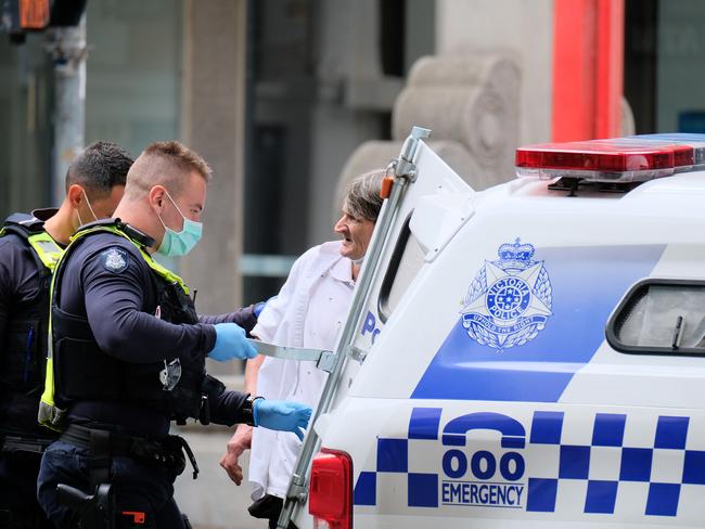 A man is questioned and detained on Sunday during Melbourne’s lockdown. Photo: NCA NewsWire / Luis Ascui