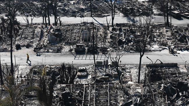 A firefighter walks past homes destroyed in the Palisades Fire in Pacific Palisades on Monday. Picture: Getty Images via AFP