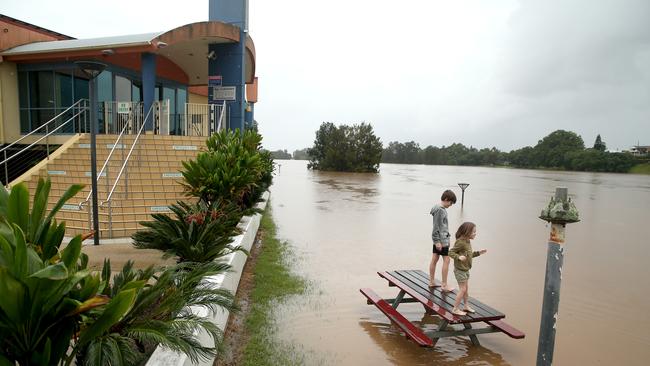 Kempsey residents check the water levels at the towns levee wall. Picture: Nathan Edwards