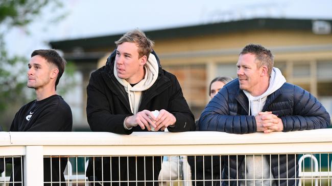 Jayden Short, Tom Lynch and Jack Riewoldt watching Soulcombe during gallops at Caulfield Racecourse on October 17, 2023. (Photo by Vince Caligiuri/Getty Images)